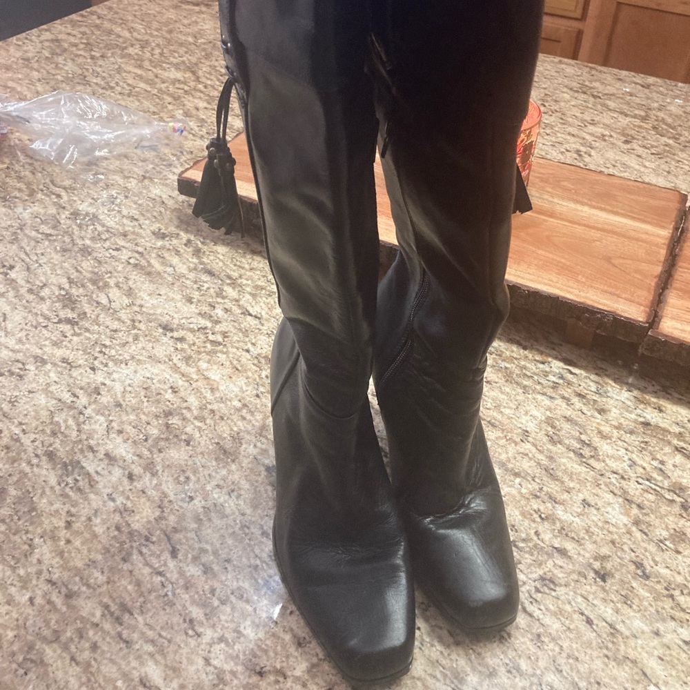 Black healed leather boots .  In great condition